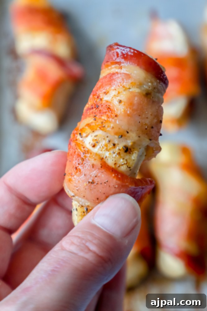 Bacon wrapped chicken bites on a baking sheet, the Best Bacon Wrapped Chicken Bites Recipe.