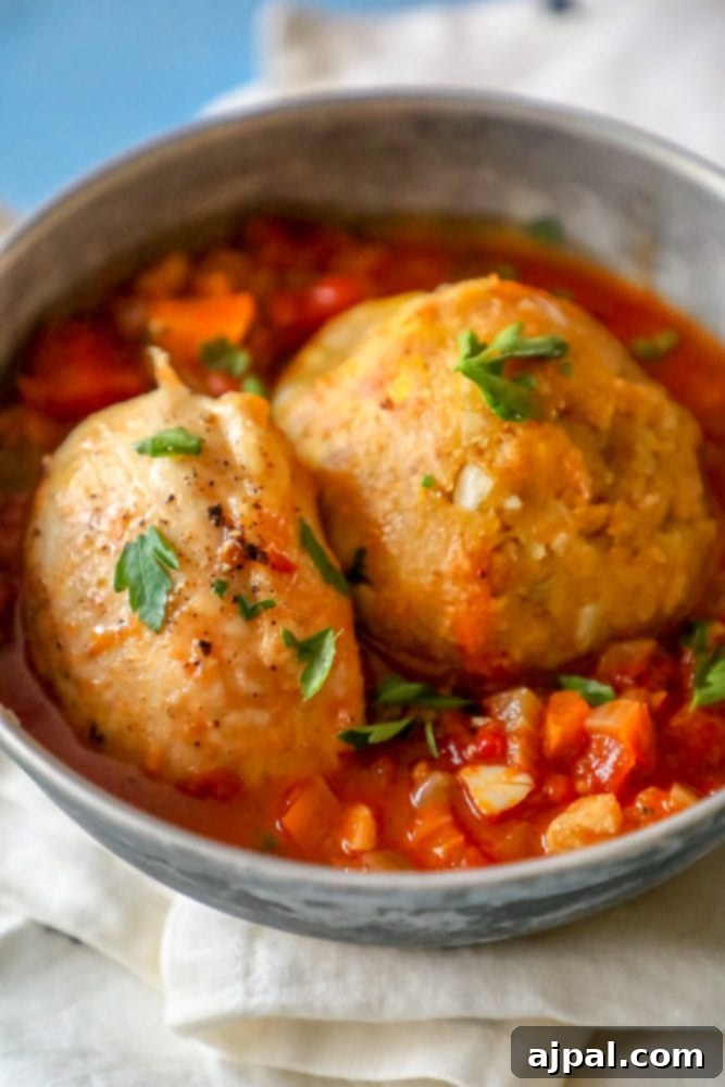 A vibrant bowl of chicken mofongo topped with rich tomato creole sauce