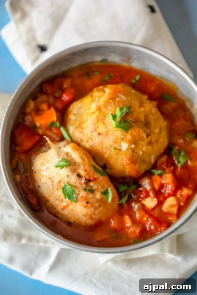 Two servings of chicken mofongo with a generous pour of creole sauce