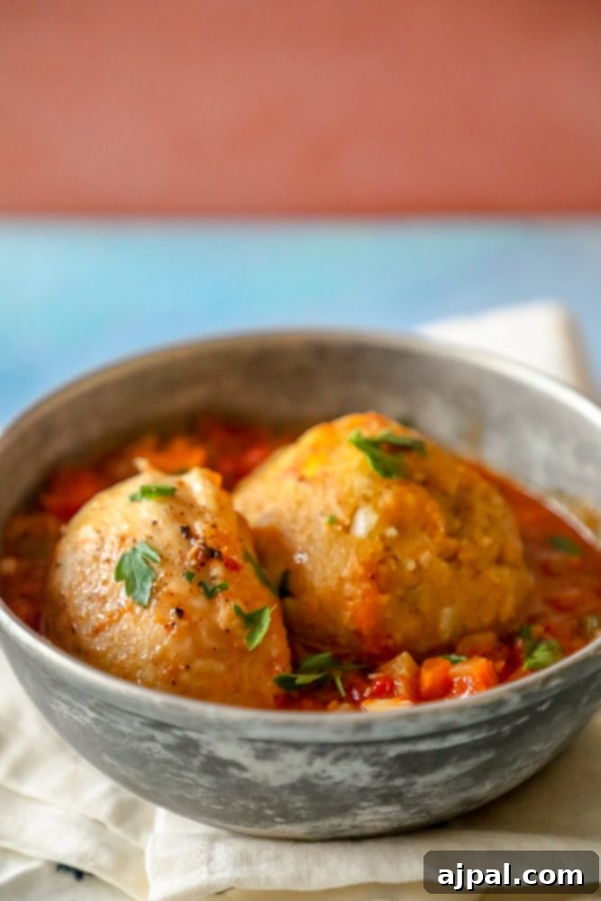 A close-up of chicken mofongo in creole sauce, ready to be served