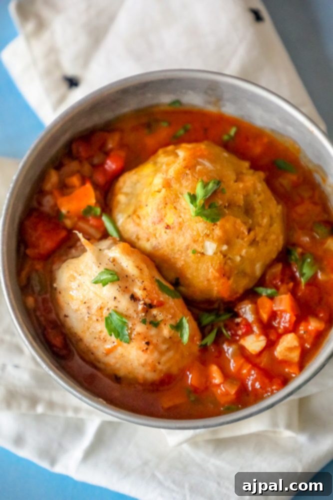 Two meatballs in a bowl with tomato sauce – Mofongo recipe with chicken.
