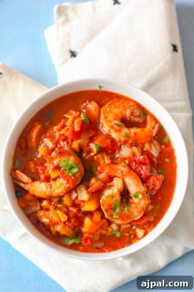 Shrimp stew in red creole sauce with a sprinkle of fresh parsley, showcasing the vibrant colors and hearty texture.