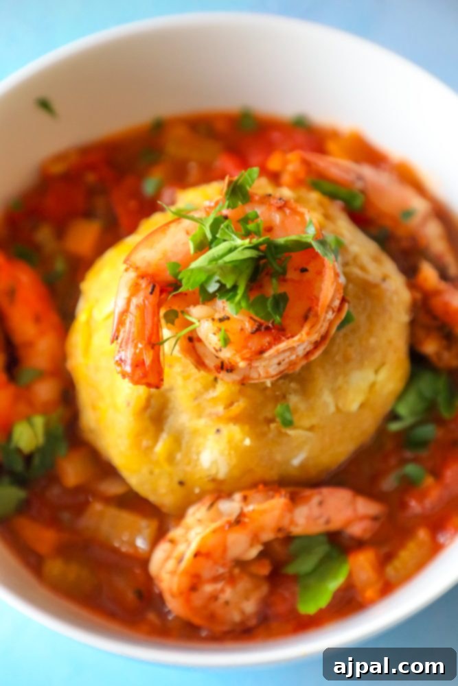 A tantalizing close-up of Shrimp Mofongo, highlighting the textures of the mashed plantains and the succulent shrimp.