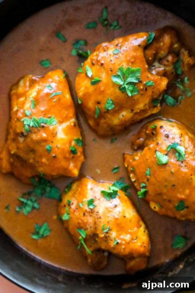 chicken with orange sauce and cilantro on it