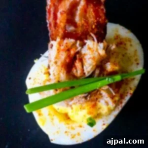 A deviled egg topped with bacon.