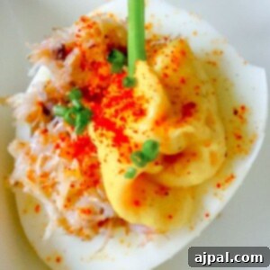 egg with creamed yoke, crab, and green onions on it