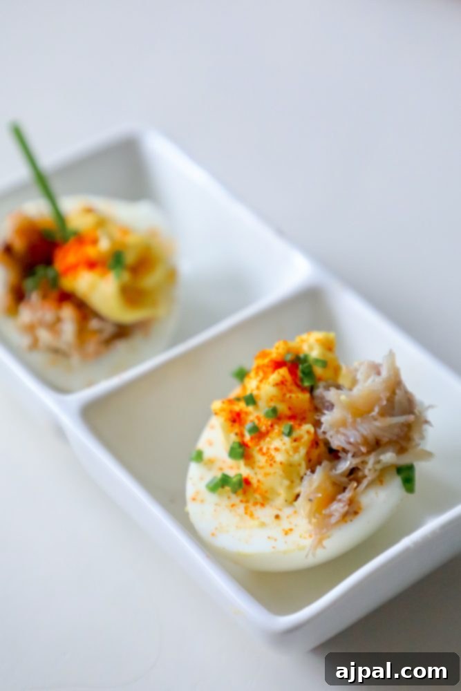 Spicy Crab Bloody Mary Deviled Eggs 5 A stunning plate of Crabby Bloody Mary Deviled Eggs, each filled with a rich, spiced yolk and succulent crab, beautifully garnished and ready to be savored.