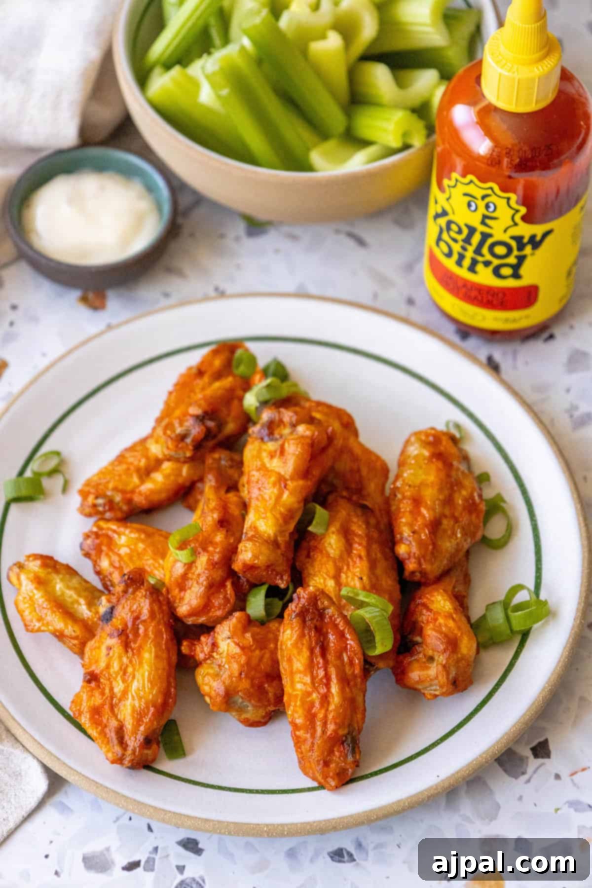 Platter of perfectly baked chicken wings, showcasing a variety of crispy textures and rich, savory coatings, inviting viewers to indulge.
