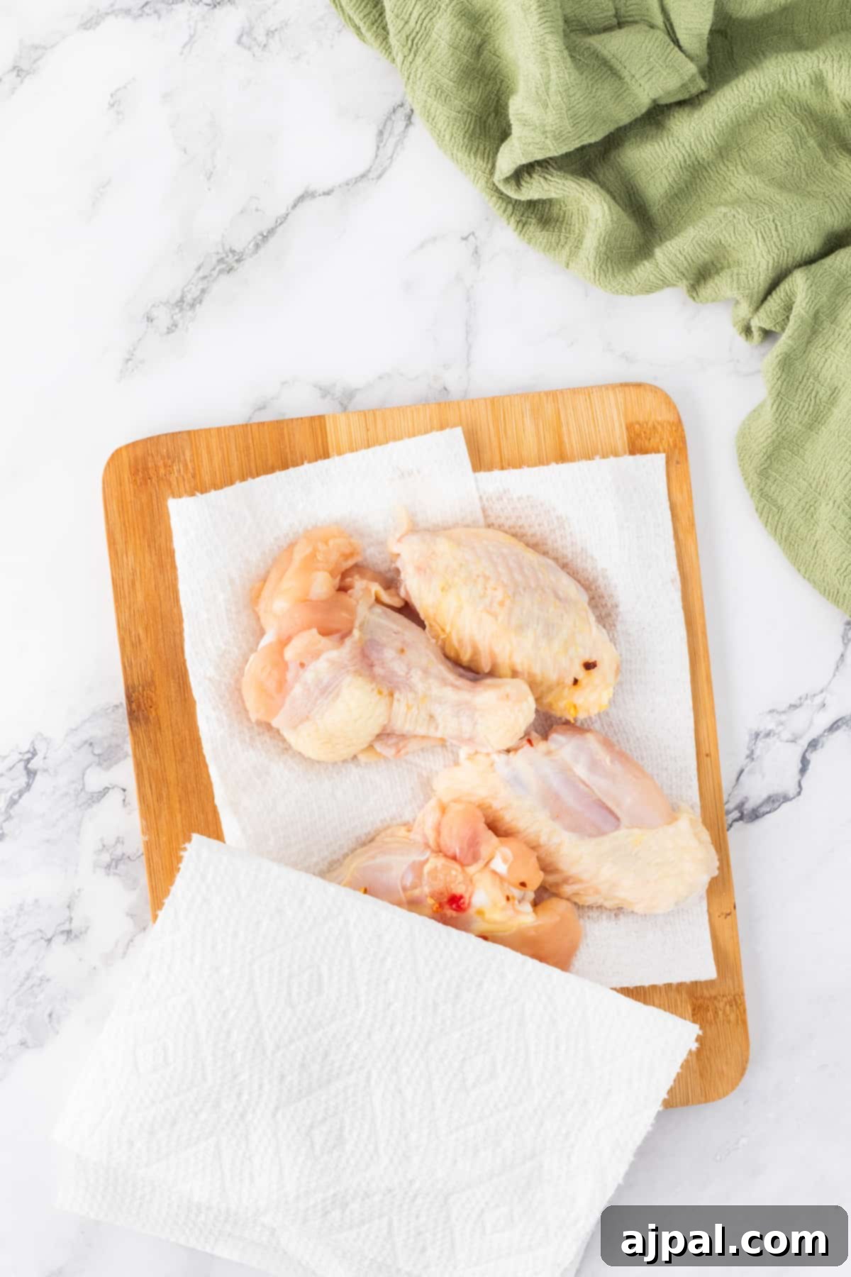 Chicken wings cooked to perfection in an air fryer, presented beautifully on a rustic wooden cutting board.