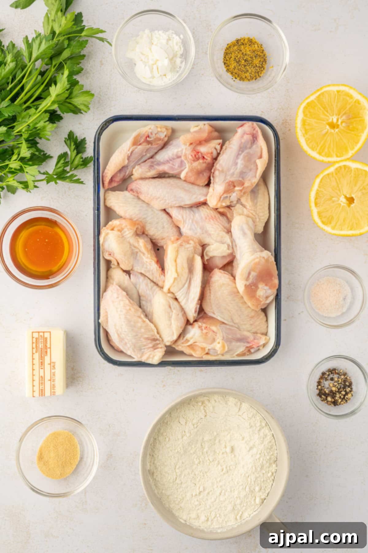 Crispy Oven Wings 7 Lemon and pepper chicken wings ingredients on a white background.