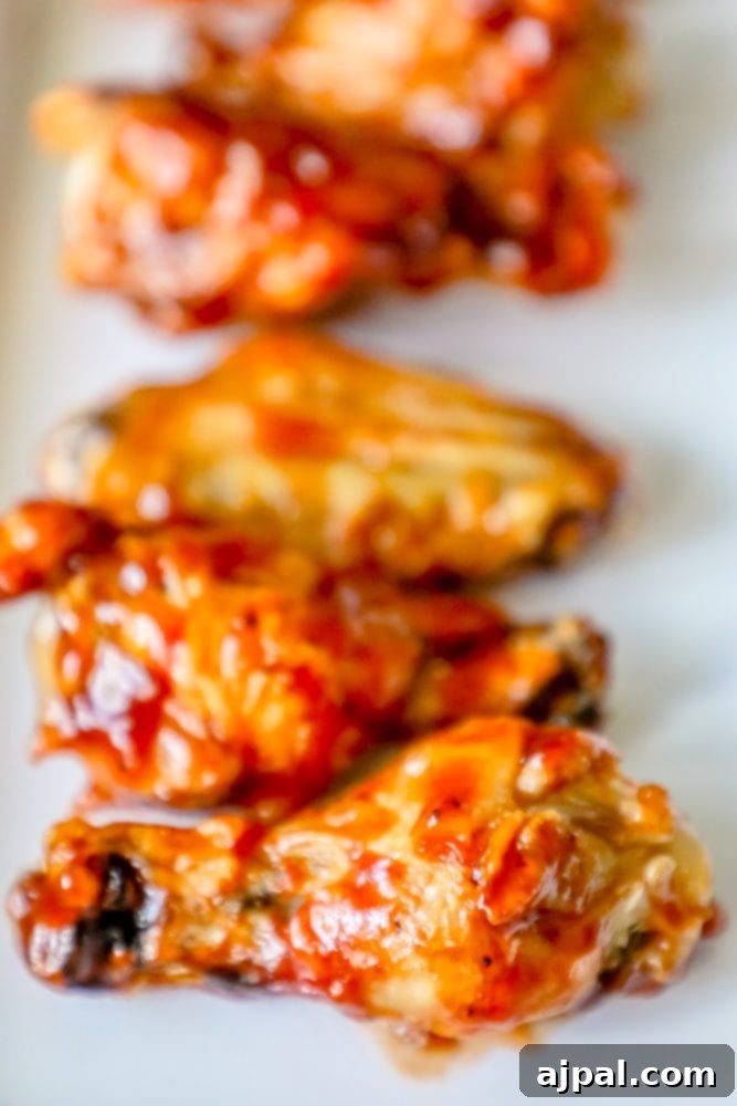 Crispy Oven BBQ Chicken Wings 2 chicken wings with red sauce on them