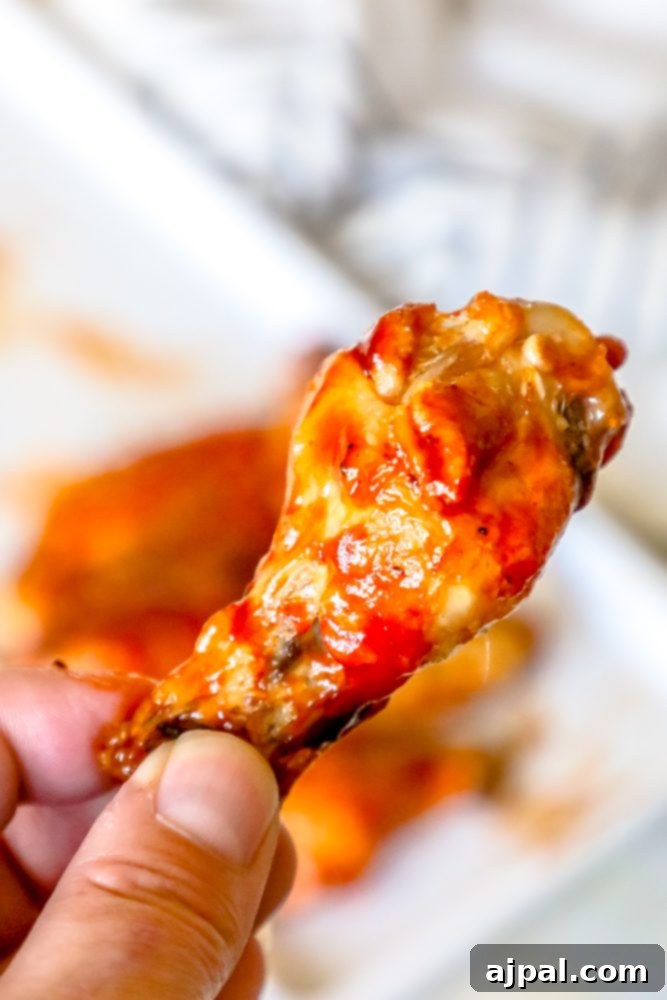 Crispy Oven BBQ Chicken Wings 7 chicken wings with red sauce on them