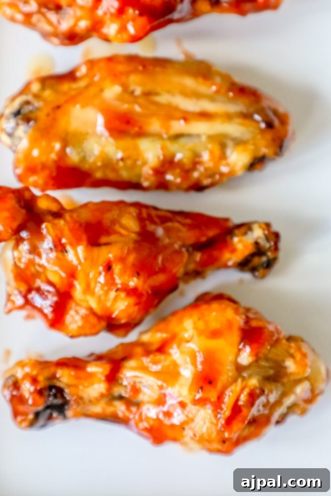 Crispy Oven BBQ Chicken Wings 6 chicken wings with red sauce on them