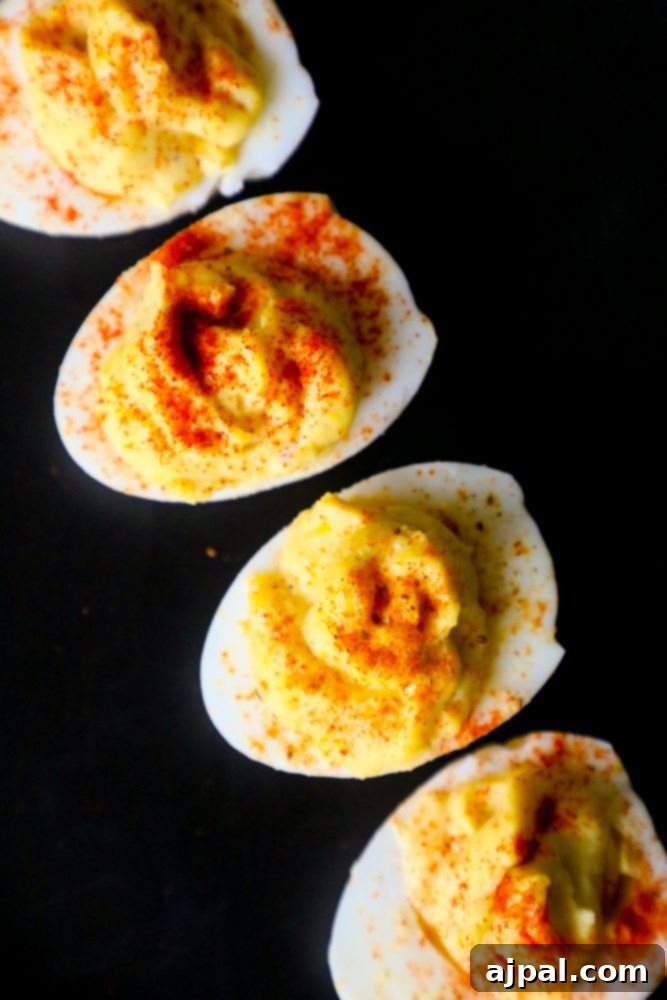Seriously Delicious Deviled Eggs 4 A plate of classic deviled eggs, garnished with paprika.
