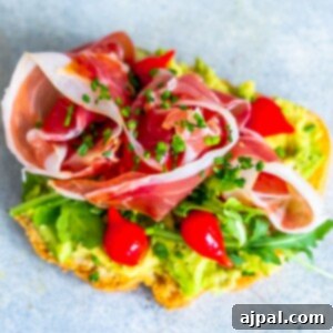 A low carb toast with ham and tomatoes on it.
