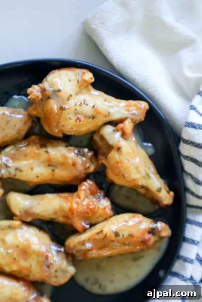 Crispy Ranch Baked Chicken Wings 3 ranch chicken wings on a black plate up close