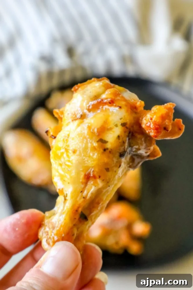Crispy Ranch Baked Chicken Wings 4 ranch chicken wings on a black plate up close one in front