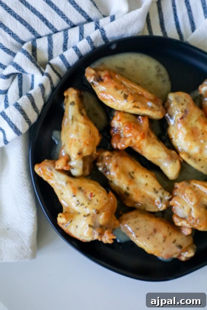 Crispy Ranch Baked Chicken Wings 5 ranch chicken wings on a black plate
