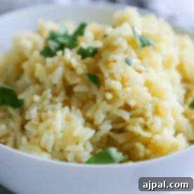 A bowl of creamy risotto, an easy rice side dish, garnished with fresh herbs.