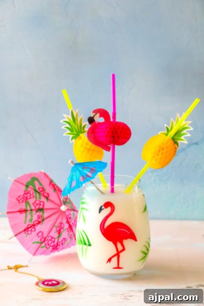 A vibrant Pina Colada cocktail in a tall glass, garnished with a tiny umbrella, evoking a sense of tropical relaxation.