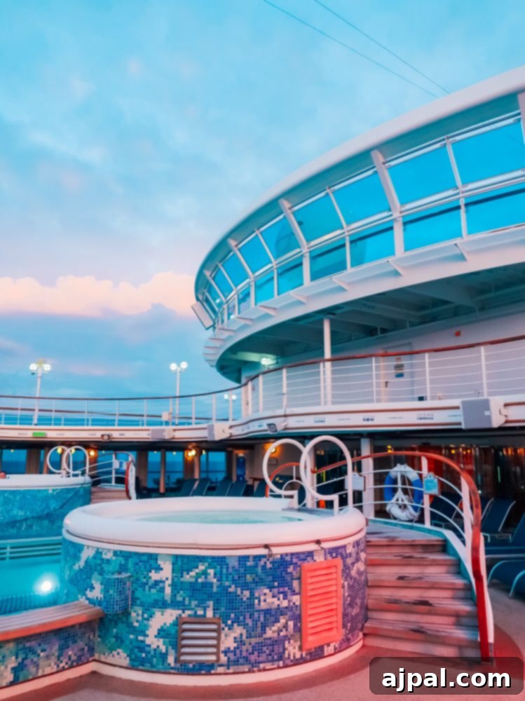 The serene pool deck on a Princess Cruises ship at dusk, illuminated with ambient lighting, enhanced by the seamless technology of OceanMedallion.