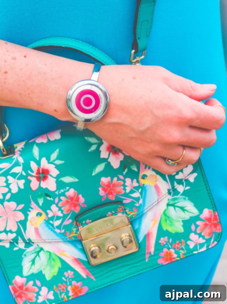 A woman elegantly displaying her Ocean Medallion bracelet, a stylish and functional accessory for her Princess Cruises vacation.