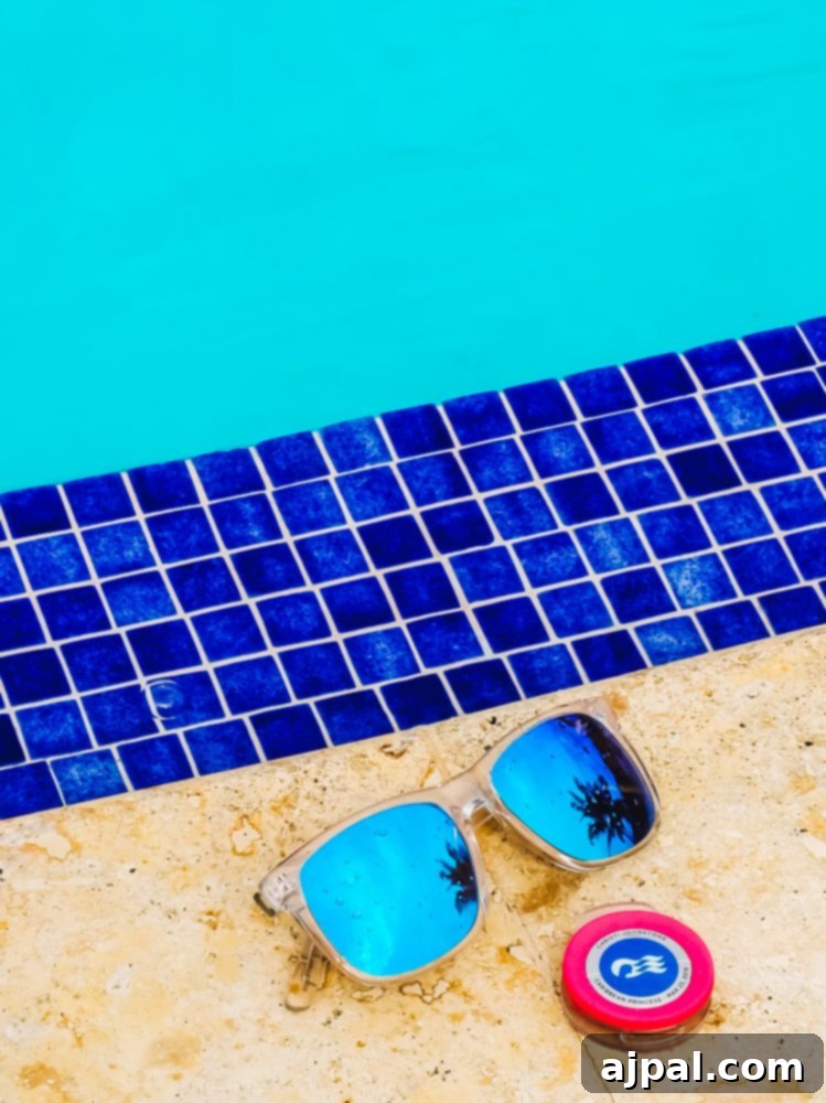 An Ocean Medallion and stylish sunglasses resting by the pool, inviting guests to relax and enjoy their cruise experience.