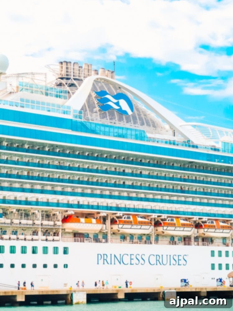 Gluten-Free Cruising on the Caribbean Princess 3 A large cruise ship docked at a dock, featuring Ocean Medallion by Princess Cruises.