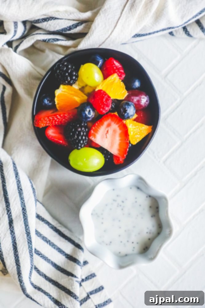A beautifully composed image featuring a bowl of lemon poppyseed glazed fruit salad next to a small bowl of chia seeds, highlighting healthy ingredients.