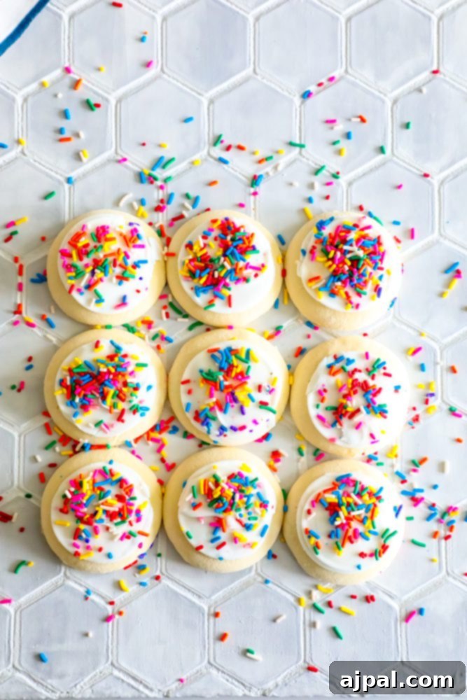 Simple Lofthouse Style Frosted Sugar Cookies 3 picture of 9 sugar cookies covered in sprinkles with sprinkles all over table