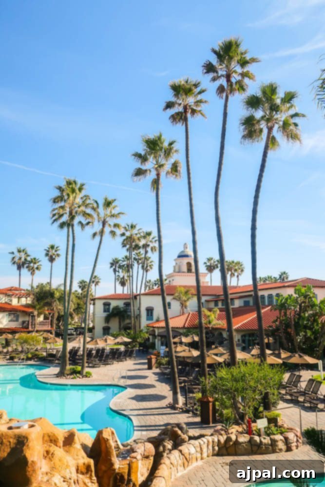 Golden State Wanderlust 5 A luxurious resort in Oxnard, California, featuring lush palm trees and a sparkling swimming pool, offering a perfect road trip stop.