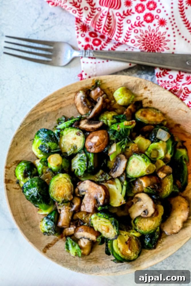 roasted Brussel sprouts and mushrooms on a wooden cutting board