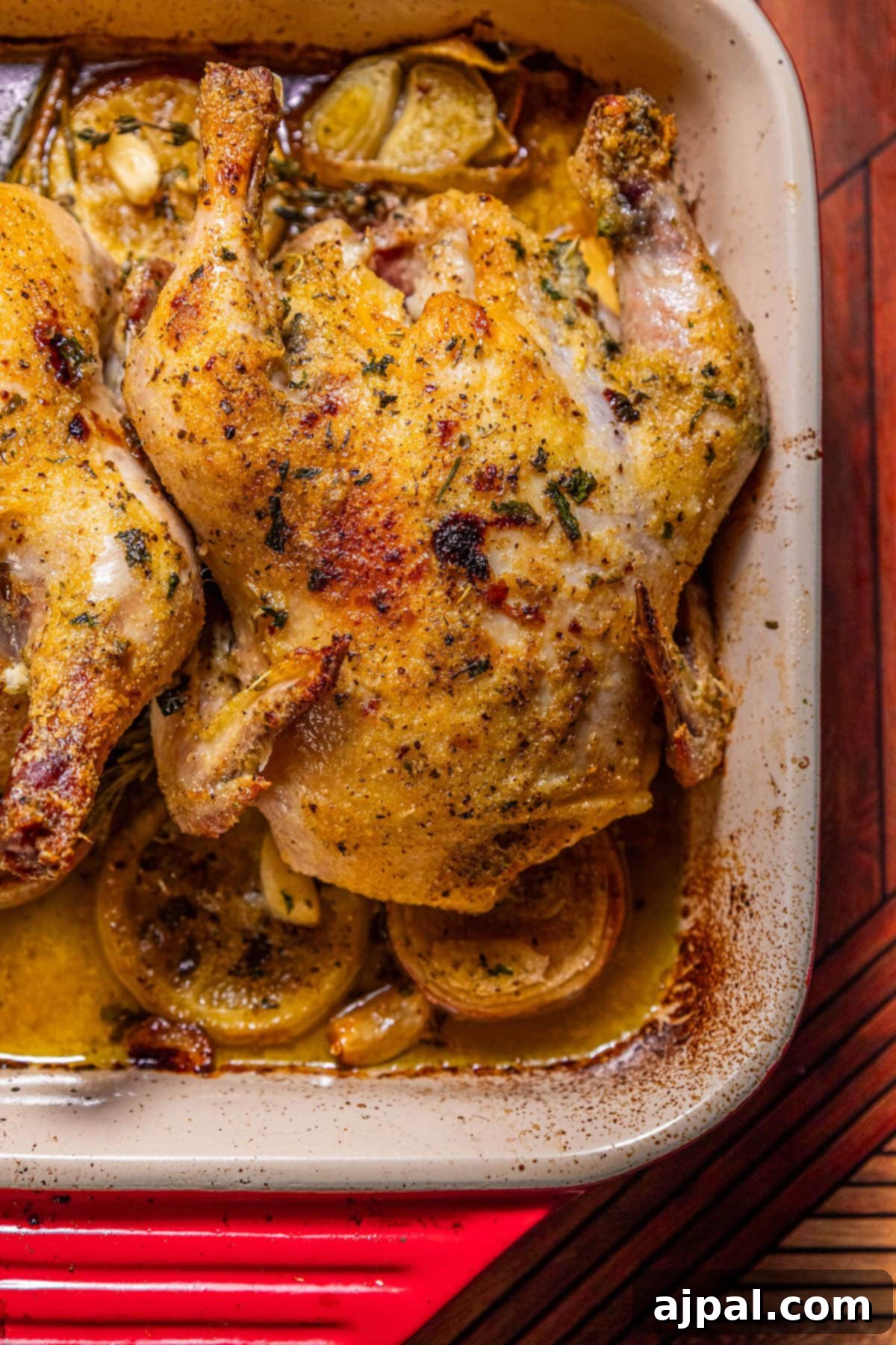 The Ultimate Cornish Game Hen Recipe 11 Crispy roasted Cornish game hen in a square baking dish with lemons, shallots, and garlic