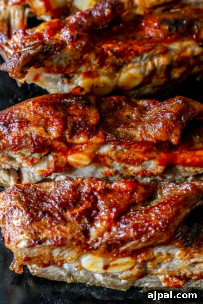 Succulent ribs covered in rich barbecue sauce, ready to be served from the slow cooker.