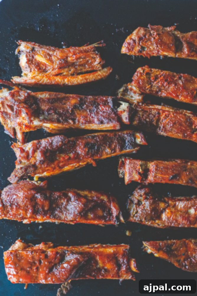Close-up of perfectly cooked slow cooker ribs with barbecue sauce, ready to be enjoyed.