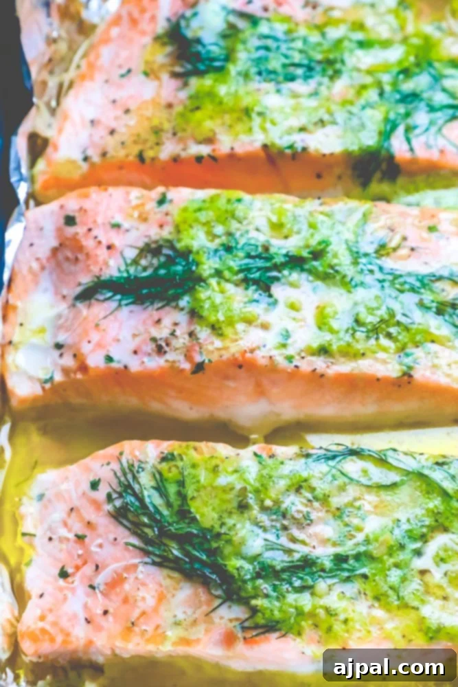 salmon on a tray with butter, pesto, and dill on it