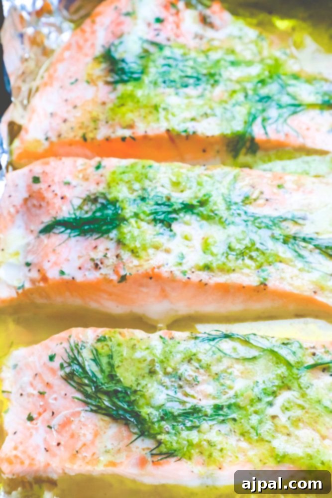 salmon on a tray with butter, pesto, and dill on it