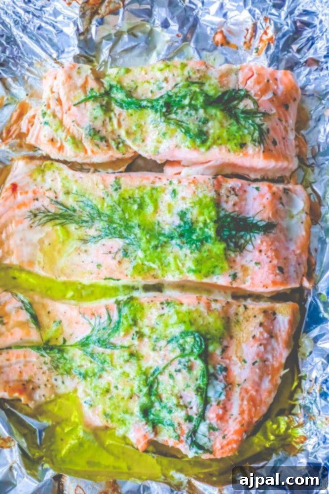 salmon on a tray with butter, pesto, and dill on it