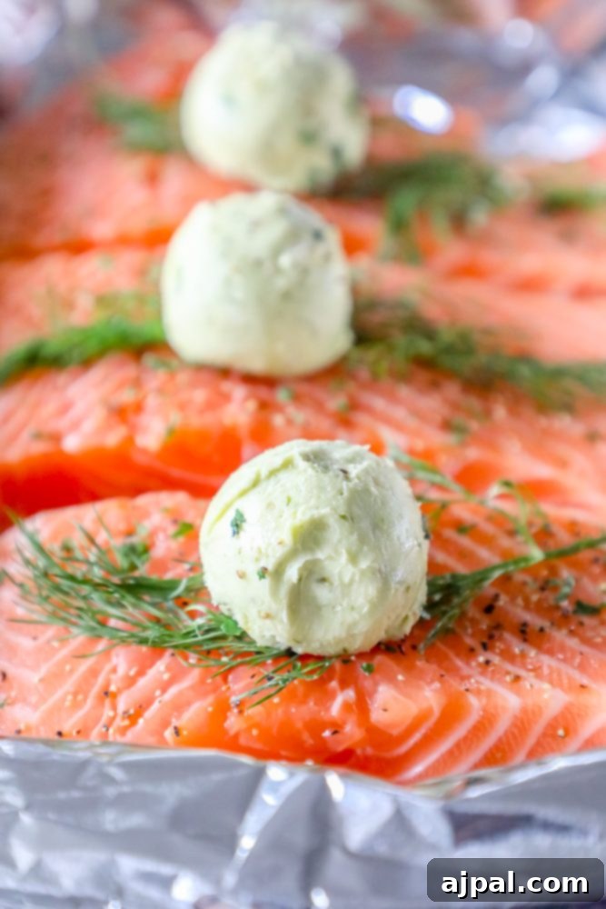 salmon on a tray with butter, pesto, and dill on it and a ball of butter
