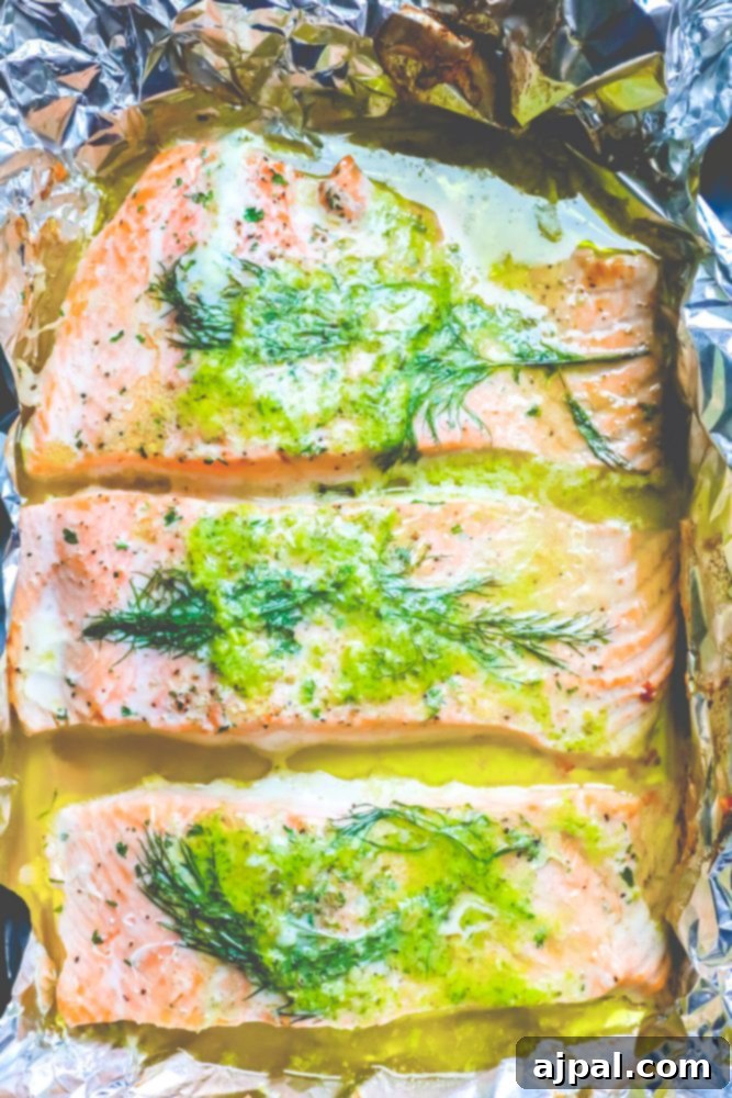 salmon on a tray with butter, pesto, and dill on it