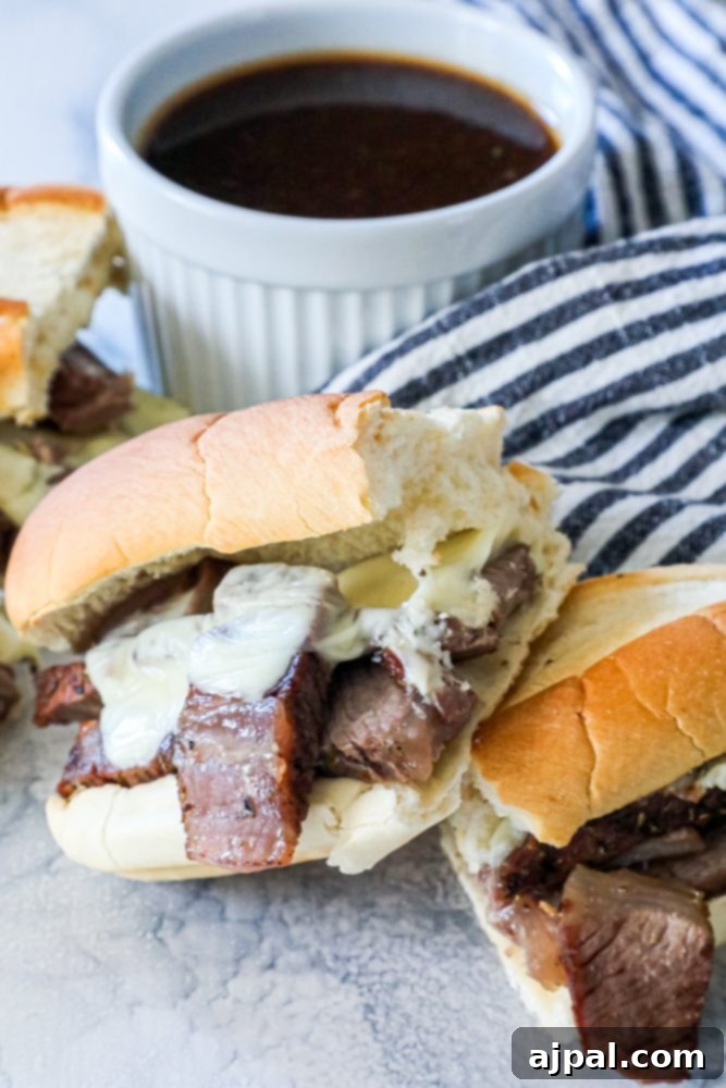 French dip sandwiches in front of au jus dip picture