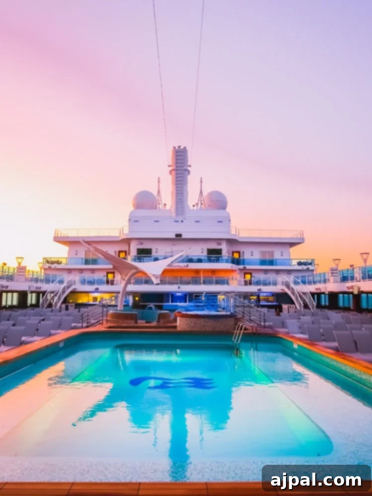 Sky Princess's Stellar Bar Hop 5 The tranquil pool on the Sky Princess cruise ship glows at sunset, creating a magical backdrop for an unforgettable Ultimate Sky Princess Bar Crawl experience.