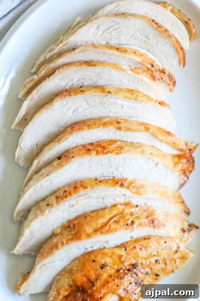 Perfect Instant Pot Turkey Breast 9 A platter featuring sliced roasted chicken, garnished with fresh herbs, ready for serving alongside your favorite holiday dishes.