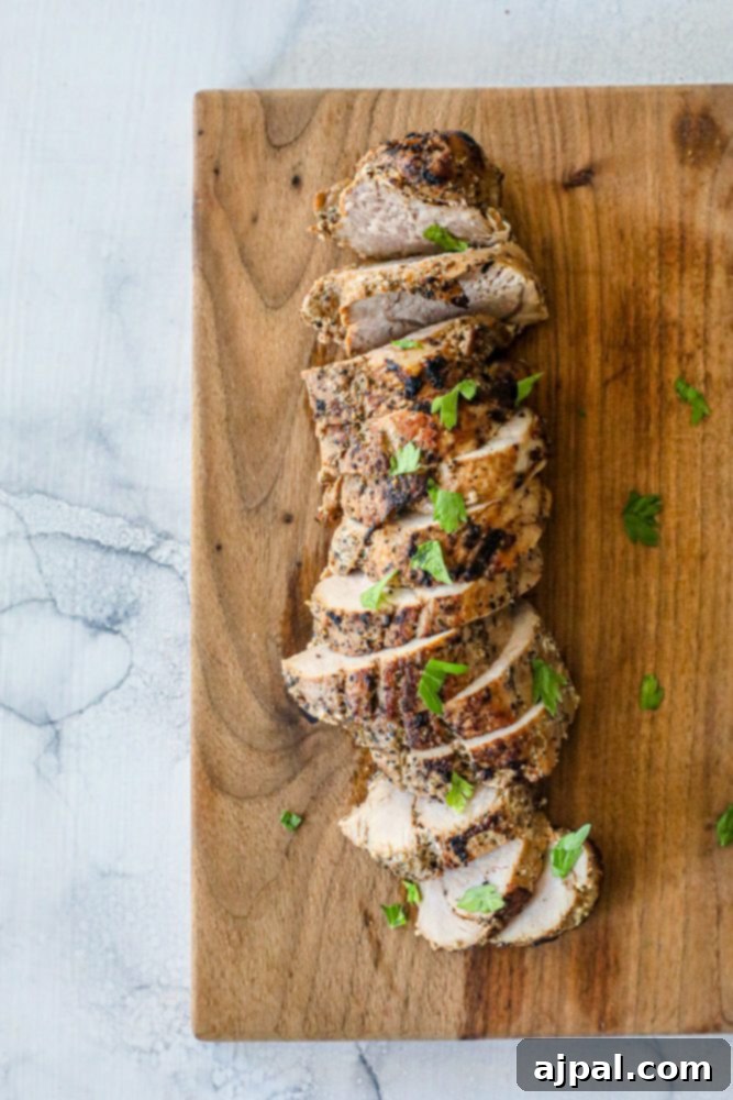 Ultimate Pressure Cooker Pork Tenderloin 9 A beautifully presented, golden-brown pork tenderloin, ready to be sliced and served.