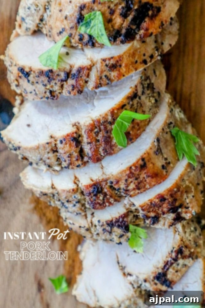 Ultimate Pressure Cooker Pork Tenderloin 4 Slices of succulent Instant Pot Pork Tenderloin arranged beautifully on a wooden cutting board with fresh herbs.