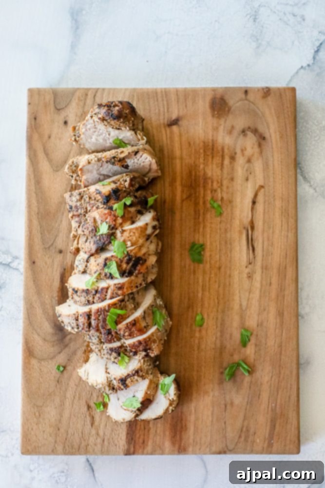 Ultimate Pressure Cooker Pork Tenderloin 5 A close-up shot of seasoned, ready-to-cook pork tenderloin, highlighting the flavorful crust.