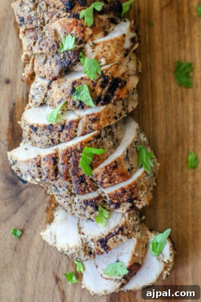 Ultimate Pressure Cooker Pork Tenderloin 6 Slices of flavorful pork tenderloin, expertly cooked and presented on a rustic wooden cutting board.