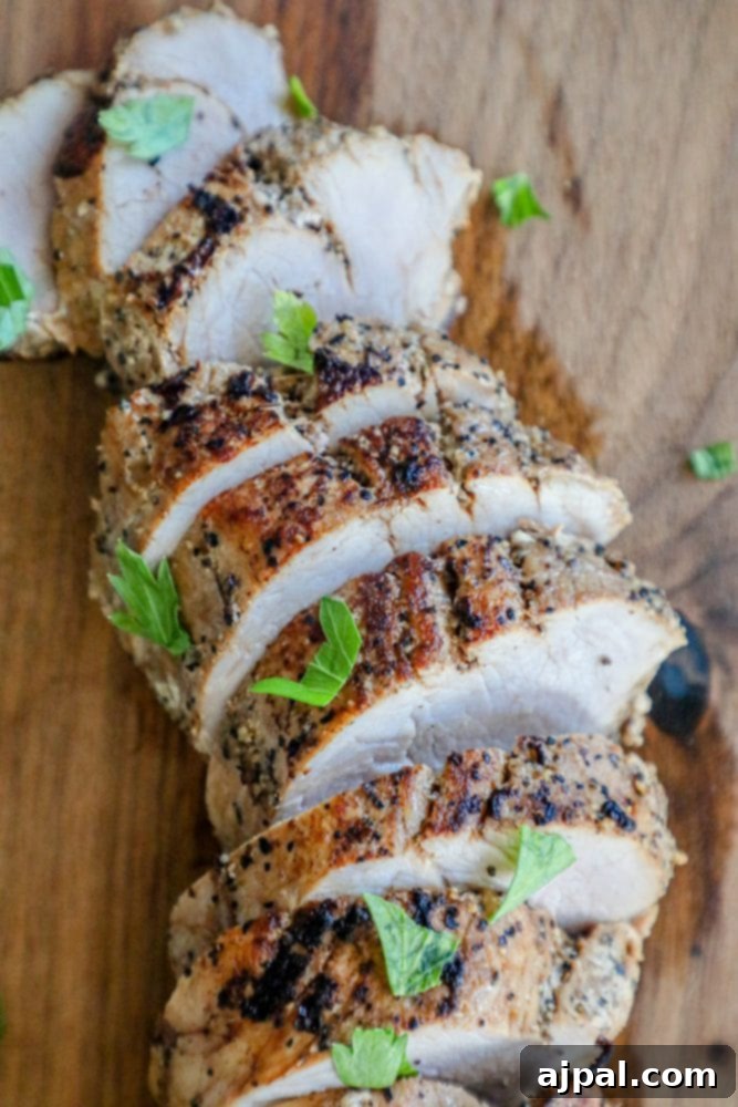 Ultimate Pressure Cooker Pork Tenderloin 7 Perfectly sliced pork tenderloin on a wooden cutting board, ready for serving, surrounded by a rustic ambiance.