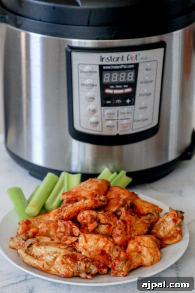 Ultimate Instant Pot Chicken Wings 4 Instant pot chicken wings served with celery sticks.