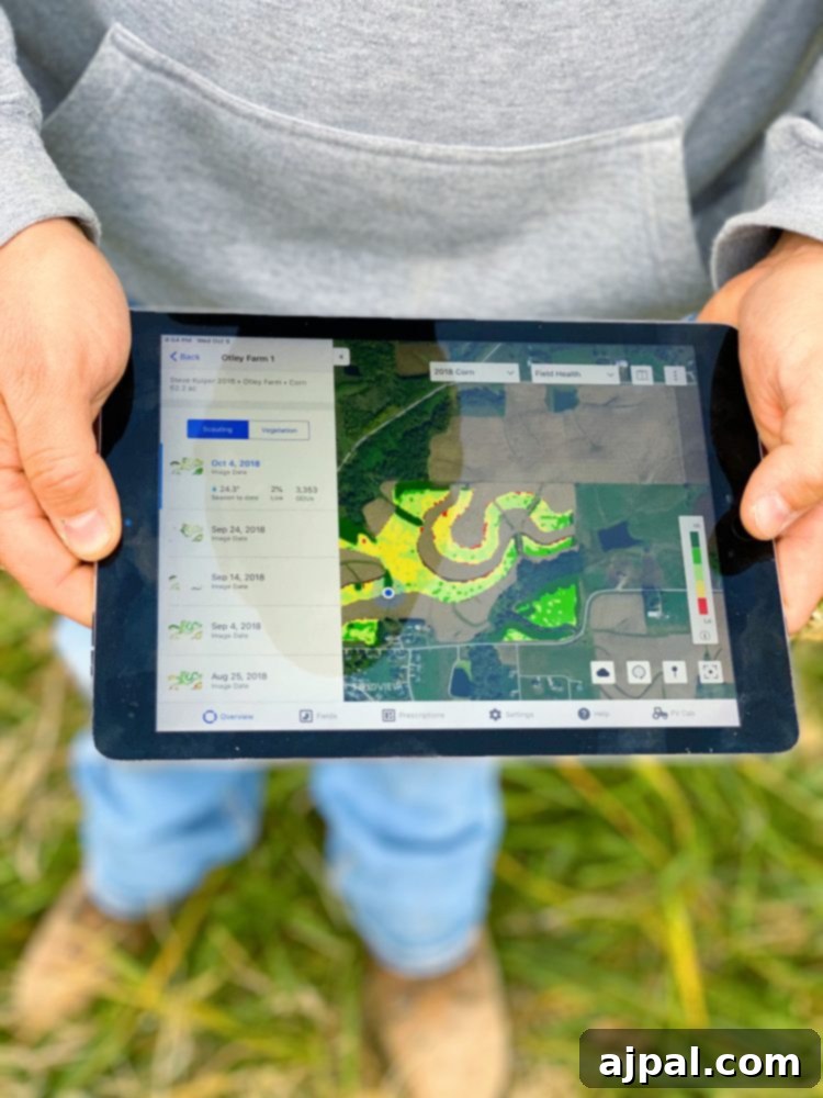 Iowa's Corn Belt: A Journey Through America's Farms 8 A man from Iowa holding up a tablet with a map of a cornfield.